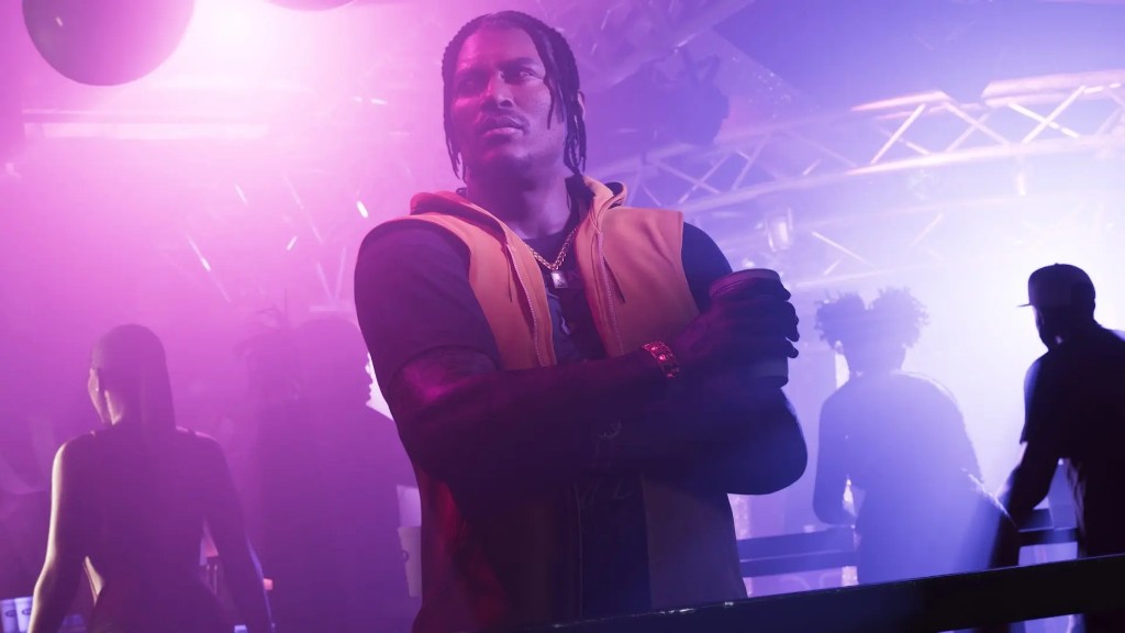 Dre'Quan Priest in a yellow hoodie at a neon club